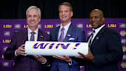 Dec 1, 2025; Baton Rouge, LA, USA; LSU president Wade Rousse, left, LSU new head coach Lane Kiffin and LSU athletic director Verge Ausberry stand together at South Stadium Club at Tiger Stadium. Mandatory Credit: Matthew Hinton-Imagn Images