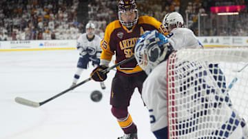 Oct 3, 2025; Tempe, AZ, USA; Penn State Nittany Lions goalie Kevin Reidler (35) makes a save against Arizona State Sun Devils forward Sean McGurn (16) during the third period at Mullett Arena. Mandatory Credit: Joe Camporeale-Imagn Images