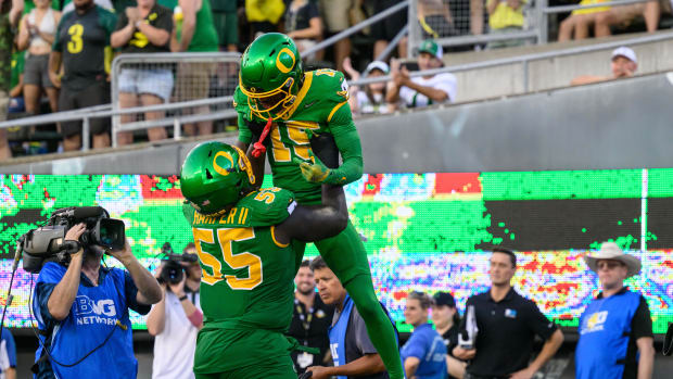 Oregon Ducks wide receiver Tez Johnson (15) celebrates a touchdown with offensive lineman Marcus Harper II (55) 