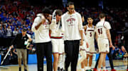 Smith is helped off the court. 