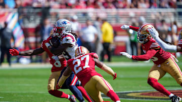 Sep 29, 2024; Santa Clara, California, USA; New England Patriots running back JaMycal Hasty (39) is tackled by San Francisco 49ers safety Ji'Ayir Brown (27) and safety Malik Mustapha (6) during the second quarter at Levi's Stadium. Mandatory Credit: Neville E. Guard-Imagn Images