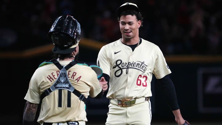 Jul 30, 2024; Phoenix, Arizona, USA; Arizona Diamondbacks catcher Jose Herrera (11) and Arizona Diamondbacks pitcher Justin Martinez (63) shake hands after defeating the Washington Nationals at Chase Field. Mandatory Credit: Joe Camporeale-USA TODAY Sports