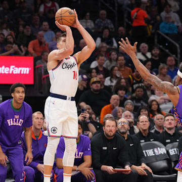 Mar 4, 2025; Phoenix, Arizona, USA; LA Clippers guard Bogdan Bogdanovic (10) shoots against Phoenix Suns guard Bradley Beal (3) during the first half at PHX Center. Mandatory Credit: Joe Camporeale-Imagn Images