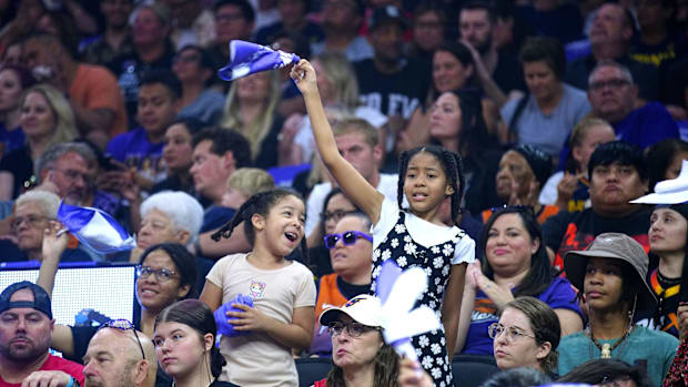 A photo of young Phoenix Mercury fans cheering