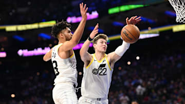 Mar 9, 2025; Philadelphia, Pennsylvania, USA; Utah Jazz center Kyle Filipowski (22) and guard Johnny Juzang (33) reach for a loose ball against the Philadelphia 76ers in the first quarter at Wells Fargo Center. Mandatory Credit: Kyle Ross-Imagn Images