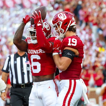 Aug 30, 2024; Norman, Oklahoma, USA;  Oklahoma Sooners wide receiver Deion Burks (6) celebrates with Oklahoma Sooners tight end Kade McIntyre (19) and Oklahoma Sooners offensive lineman Spencer Brown (58) after scoring during the first quarter against the Temple Owls at Gaylord Family-Oklahoma Memorial Stadium. Mandatory Credit: Kevin Jairaj-Imagn Images