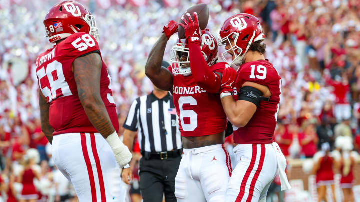 Aug 30, 2024; Norman, Oklahoma, USA;  Oklahoma Sooners wide receiver Deion Burks (6) celebrates with Oklahoma Sooners tight end Kade McIntyre (19) and Oklahoma Sooners offensive lineman Spencer Brown (58) after scoring during the first quarter against the Temple Owls at Gaylord Family-Oklahoma Memorial Stadium. 