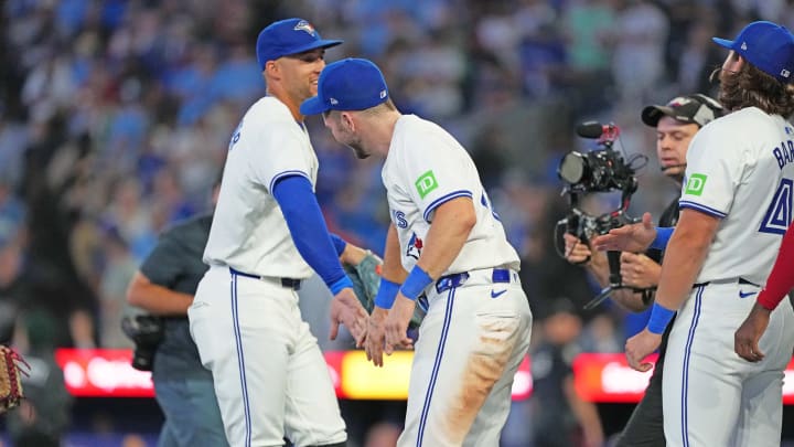 Toronto Blue Jays right fielder George Springer (4) celebrates the win with designated hitter Spencer Horwitz (48) against the Oakland Athletics at the end of the ninth inning at Rogers Centre on Aug 9.