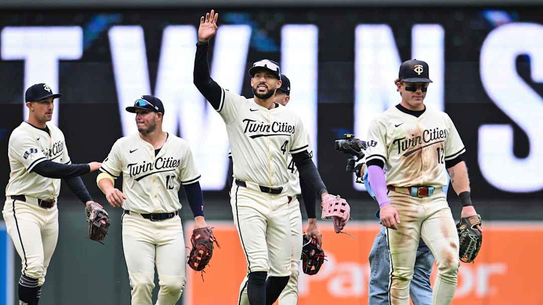 Apr 27, 2025; Minneapolis, Minnesota, USA; Minnesota Twins shortstop Carlos Correa (4) reacts to the crowd with outfielder Harrison Bader (12) and teammates after the game against the Los Angeles Angels at Target Field. Mandatory Credit: Jeffrey Becker-Imagn Images
