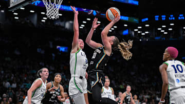 Aug 10, 2025; Brooklyn, New York, USA; New York Liberty guard Sabrina Ionescu (20) shoots against Minnesota Lynx forward Alanna Smith (8) during the first half at Barclays Center. Mandatory Credit: John Jones-Imagn Images