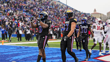 Nov 28, 2025; Lawrence, Kansas, USA; Kansas Jayhawks running back Daniel Hishaw Jr. (9) celebrates after scoring a touchdown during the first half against the Utah Utes at David Booth Kansas Memorial Stadium. Mandatory Credit: Jay Biggerstaff-Imagn Images