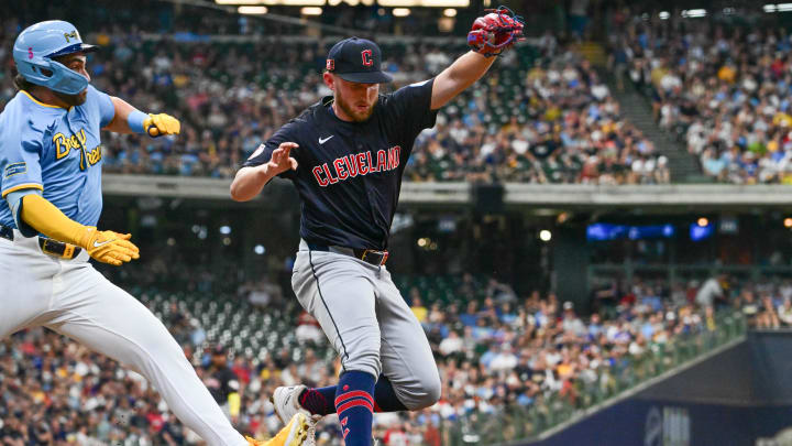 Aug 17, 2024; Milwaukee, Wisconsin, USA; Cleveland Guardians starting pitcher Tanner Bibee (28) beats Milwaukee Brewers center fielder Garrett Mitchell (5) to first base for the putout in the second inning at American Family Field. Mandatory Credit: Benny Sieu-USA TODAY Sports