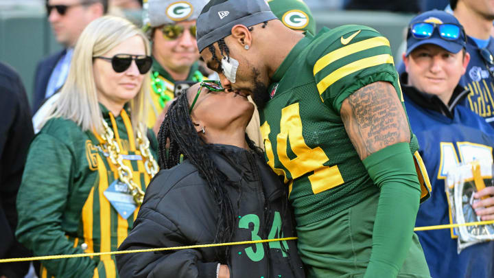 Nov 19, 2023; Green Bay, Wisconsin, USA; Green Bay Packers safety Jonathan Owens (34) kisses his wife, Olympic gymnast Simone Biles, before game against the Los Angeles Chargers at Lambeau Field. 