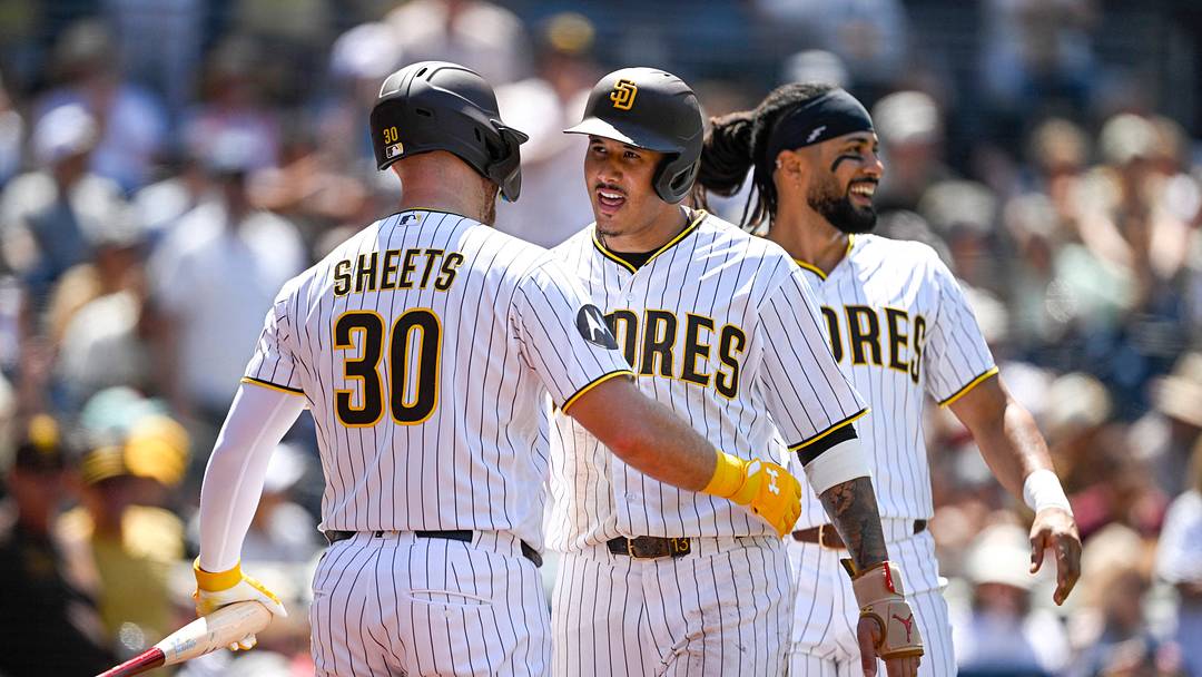 Aug 26, 2026; San Diego, California, USA;  San Diego Padres third baseman Manny Machado (13), center, is congratulated by designated hitter Gavin Sheets (30) and right fielder Fernando Tatis Jr. (23) after scoring during the fourth inning against the Pittsburgh Pirates at Petco Park.  Mandatory Credit: Denis Poroy-Imagn Images