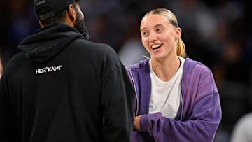 Oct 6, 2025; Fort Worth, Texas, USA; Dallas Mavericks guard Kyrie Irving (left) talks with Dallas Wings guard Paige Bueckers (right) during the second half of the game between the Mavericks and the Oklahoma City Thunder at Dickie's Arena. Mandatory Credit: Jerome Miron-Imagn Images