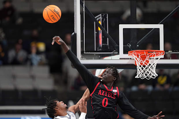 San Diego State center Magoon Gwath blocks a shot by Cal guard Jeremiah Wilkinson.