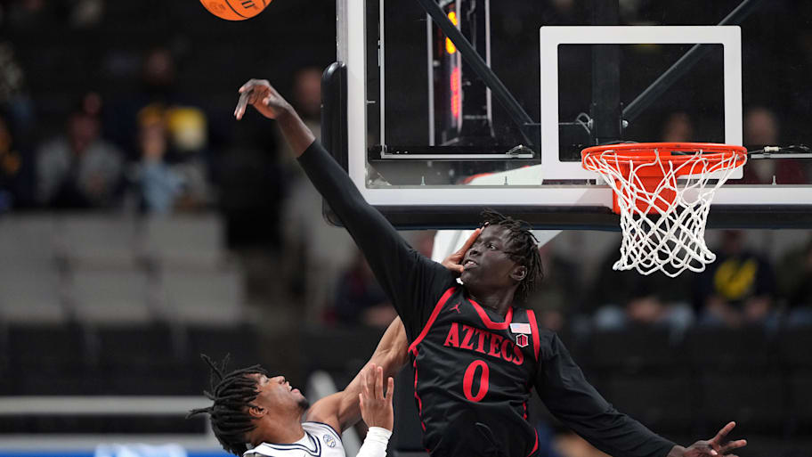 San Diego State center Magoon Gwath blocks a shot by Cal guard Jeremiah Wilkinson.