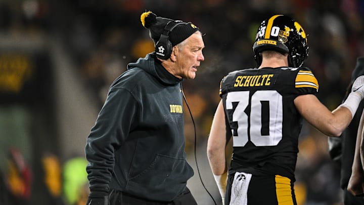 Nov 29, 2024; Iowa City, Iowa, USA; Iowa Hawkeyes head coach Kirk Ferentz reacts as defensive back Quinn Schulte (30) looks on during the first quarter against the Nebraska Cornhuskers at Kinnick Stadium.