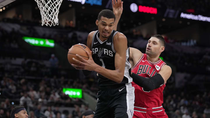 San Antonio Spurs center Victor Wembanyama (1) rebounds in front of Chicago Bulls center Nikola Vucevic (9) in the first quarter at the Frost Bank Center. Mandatory Credit: Daniel Dunn-USA TODAY Sports