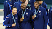 Aug 10, 2024; Paris, France; United States shooting guard Stephen Curry (4) and guard LeBron James (6) and guard Kevin Durant (7) celebrate with their gold medals on the podium after defeating France in the men's basketball gold medal game during the Paris 2024 Olympic Summer Games at Accor Arena. Mandatory Credit: Rob Schumacher-Imagn Images