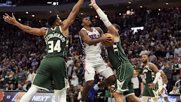 Oct 26, 2023; Milwaukee, Wisconsin, USA;  Philadelphia 76ers guard Tyrese Maxey (0) drives for the basket between Milwaukee Bucks forward Giannis Antetokounmpo (34) ad center Brook Lopez (11) during the fourth quarter at Fiserv Forum. Mandatory Credit: Jeff Hanisch-Imagn Images