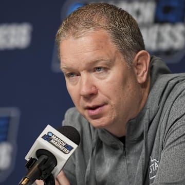Mar 19, 2025; Lexington, KY, USA;  Utah State head coach Jerrod Calhoun talks with media during NCAA Tournament First Round Practice at Rupp Arena. Mandatory Credit: Aaron Doster-Imagn Images