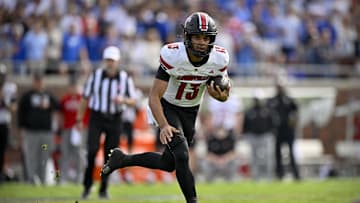 Nov 22, 2025; Dallas, Texas, USA; Louisville Cardinals quarterback Deuce Adams (13) runs with the ball against the SMU Mustangs during the first half at Gerald J. Ford Stadium. Mandatory Credit: Jerome Miron-Imagn Images