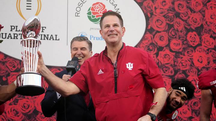 Jan 1, 2026; Pasadena, CA, USA; Indiana Hoosiers head coach Curt Cignetti celebrates with the trophy on the podium after defeating the Alabama Crimson Tide in the 2026 Rose Bowl and quarterfinal game of the College Football Playoff at Rose Bowl Stadium. Mandatory Credit: Kirby Lee-Imagn Images