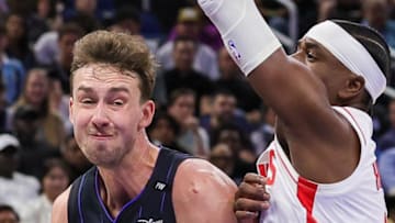 Orlando Magic forward Franz Wagner drives to the basket against Houston Rockets guard Aaron Holiday