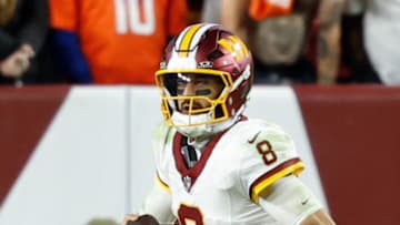 Washington Commanders quarterback Marcus Mariota under pressure from Denver Broncos linebacker Dre Greenlaw