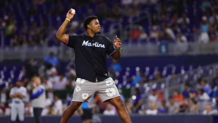 Jul 19, 2024; Miami, Florida, USA; Miami Dolphins linebacker Chop Robinson throws the ceremonial first pitch before the game between the Miami Marlins and the New York Mets at loanDepot Park.