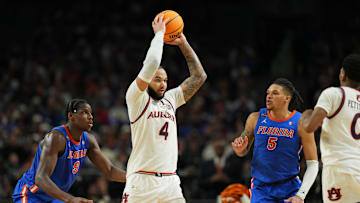 Apr 5, 2025; San Antonio, TX, USA; Auburn Tigers forward Johni Broome (4) holds the ball against the Florida Gators during the second half in the semifinals of the men's Final Four of the 2025 NCAA Tournament at the Alamodome. Mandatory Credit: Bob Donnan-Imagn Images