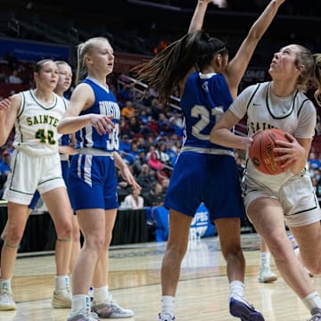 Council Bluffs St. Albert's Payton Johnsen drives to the basket against Newell-Fonda's Mareni Brabec during the 1A IGHSAU state basketball championship at Wells Fargo Arena on Saturday, March 8, 2025, in Des Moines.