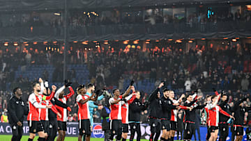 The players and coaches of Feyenoord salute their fans after a famous victory over Bayern Munich.