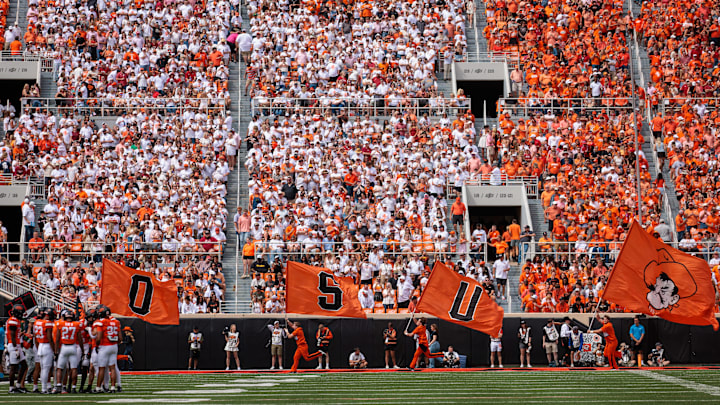 Sep 7, 2024; Stillwater, Oklahoma, USA; Oklahoma State Cowboys flag team on the field after a touchdown during the second quarter against the Arkansas Razorbacks at Boone Pickens Stadium. Mandatory Credit: William Purnell-Imagn Images