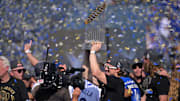 Nov 3, 2025; Los Angeles, CA, USA; Los Angeles Dodgers first baseman Enrique Hernandez (8) holds the World Series Commissioners Trophy during the World Series celebration at Dodger Stadium. Mandatory Credit: Jayne Kamin-Oncea-Imagn Images