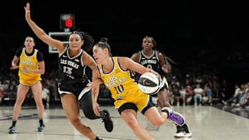 Jun 11, 2025; Las Vegas, Nevada, USA; Los Angeles Sparks guard Kelsey Plum (10) drives the ball past Las Vegas Aces guard Aaliyah Nye (13) during the second half of a WNBA basketball game at Michelob Ultra Arena. Mandatory Credit: Lucas Peltier-Imagn Images
