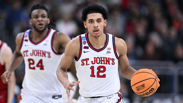 St. John's Red Storm guard RJ Luis Jr. (12) dribbles the ball during a game against Arkansas.