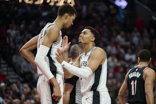 San Antonio Spurs forward Keldon Johnson (3) talks to center Victor Wembanyama (1) during the second half against the Blazers