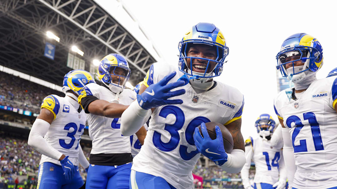 Nov 3, 2024; Seattle, Washington, USA; Los Angeles Rams safety Jaylen McCollough (39) celebrates with teammates, including cornerback Ahkello Witherspoon (4) and cornerback Charles Woods (21) following a first quarter interception against the Seattle Seahawks at Lumen Field. Mandatory Credit: Joe Nicholson-Imagn Images