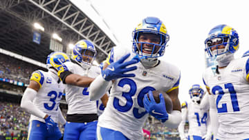 Nov 3, 2024; Seattle, Washington, USA; Los Angeles Rams safety Jaylen McCollough (39) celebrates with teammates, including cornerback Ahkello Witherspoon (4) and cornerback Charles Woods (21) following a first quarter interception against the Seattle Seahawks at Lumen Field. Mandatory Credit: Joe Nicholson-Imagn Images