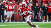 Sep 6, 2025; Lincoln, Nebraska, USA; Nebraska Cornhuskers running back Emmett Johnson (21) runs against the Akron Zips during the second quarter at Memorial Stadium. Mandatory Credit: Dylan Widger-Imagn Images