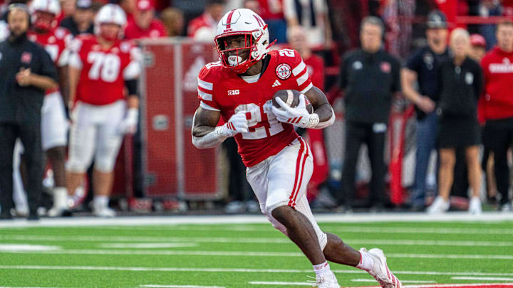 Sep 6, 2025; Lincoln, Nebraska, USA; Nebraska Cornhuskers running back Emmett Johnson (21) runs against the Akron Zips during the second quarter at Memorial Stadium. Mandatory Credit: Dylan Widger-Imagn Images