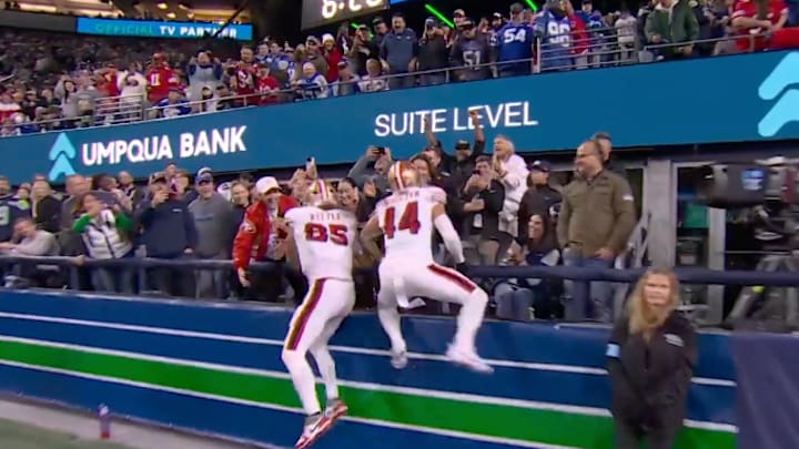 San Francisco 49ers tight end George Kittle (No. 85) and fullback Kyle Jusczcyk (No. 44) celebrate a fourth-quarter touchdown with their wives in the stands during a 36-24 win over the Seattle Seahawks on Thursday night at Lumen Field. 