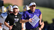 Oct 4, 2025; College Park, Maryland, USA;  Washington Huskies head coach Jedd Fisch leads his team on to the field before a game against the Maryland Terrapins at SECU Stadium. Mandatory Credit: Jamie Sabau-Imagn Images