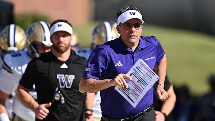 Oct 4, 2025; College Park, Maryland, USA;  Washington Huskies head coach Jedd Fisch leads his team on to the field before a game against the Maryland Terrapins at SECU Stadium. Mandatory Credit: Jamie Sabau-Imagn Images