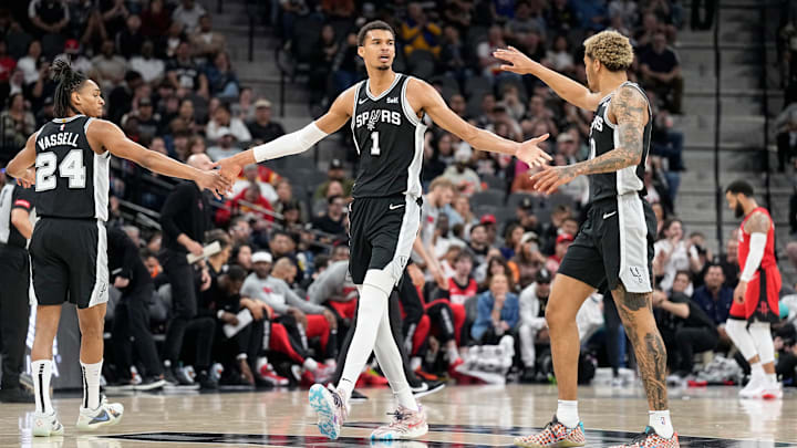 Mar 12, 2024; San Antonio, Texas, USA; San Antonio Spurs forward Victor Wembanyama (1) reacts with guard Devin Vassell (24) and forward Jeremy Sochan (10) before a time out during the first half against the Houston Rockets at Frost Bank Center.