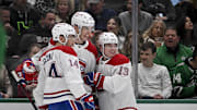 Jan 16, 2025; Dallas, Texas, USA; Montreal Canadiens center Nick Suzuki (14) and left wing Juraj Slafkovsky (20) and right wing Cole Caufield (13) celebrates a goal scored Slafkovsky against the Dallas Stars during the first period at the American Airlines Center. Mandatory Credit: Jerome Miron-Imagn Images