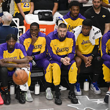 Apr 9, 2025; Dallas, Texas, USA; Los Angeles Lakers guard Luka Doncic (77) looks on from the team bench during the game between the Dallas Mavericks and the Los Angeles Lakers at American Airlines Center. Mandatory Credit: Jerome Miron-Imagn Images
