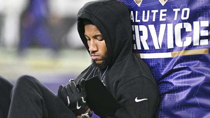 Baltimore Ravens cornerback Marlon Humphrey sits and reads a tablet before a game against the Cincinnati Bengals